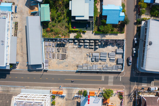 Aerial top view of concrete industry factory in urban city town. Business distribution logistic transport in Thailand.