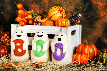 BOO ghost toys and a box of pumpkins. Holiday Halloween concept.