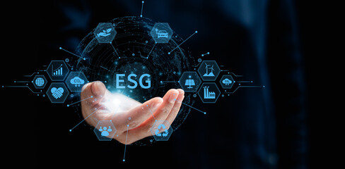 Businesswomen holding a virtual globe with ESG icon concepts for Environment, Social, Governance, net zero, carbon neutrality goals, development business sustainable environment concept.