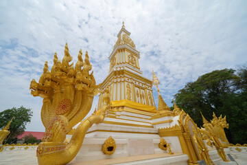 Fototapeta premium Wat Phrathat Phanom, Nakhon Phanom, Isan Temple. The pagoda is a buddhist temple in urban city town, Thailand. Thai architecture landscape background. Tourist attraction landmark.