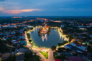 Aerial view of residential neighborhood roofs. Urban housing development from above. Top view. Real estate in Kalasin, Isan province city, Thailand. Property real estate at night.