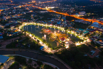 Obraz premium Aerial view of residential neighborhood roofs. Urban housing development from above. Top view. Real estate in Kalasin, Isan province city, Thailand. Property real estate at night.