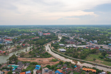 Fototapeta na wymiar Aerial view of residential neighborhood roofs. Urban housing development from above. Top view. Real estate in Kalasin, Isan province city, Thailand. Property real estate.