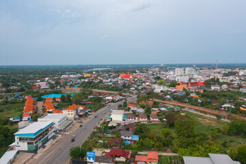 Naklejka premium Aerial view of residential neighborhood roofs. Urban housing development from above. Top view. Real estate in Kalasin, Isan province city, Thailand. Property real estate.