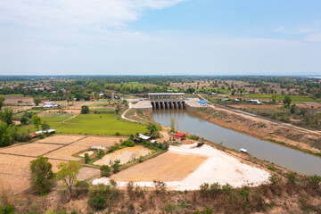 Aerial view of dam tower crane. Reservoir and sea water in recycle energy industry concept for electricity in Natural landscape background in Thailand. Environment.