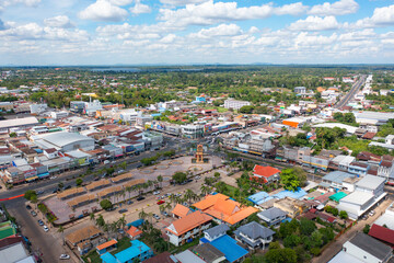 Fototapeta premium Aerial view of local residential neighborhood roofs. Urban housing development from above. Top view. Real estate in Isan urban city town, Thailand. Property real estate.