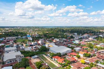 Fototapeta na wymiar Aerial view of local residential neighborhood roofs. Urban housing development from above. Top view. Real estate in Isan urban city town, Thailand. Property real estate.