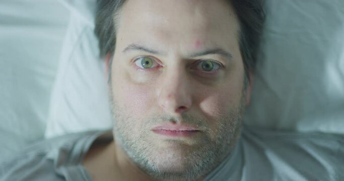 Man sleeping opening eye lights alien abduction ghost closeup