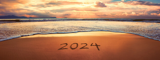 2024 year written on sandy beach - Powered by Adobe