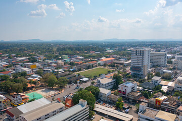 Obraz premium Aerial view of local residential neighborhood roofs. Urban housing development from above. Top view. Real estate in Isan urban city town, Thailand. Property real estate.