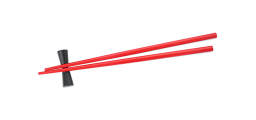 Pair of red chopsticks with rest isolated on white, top view