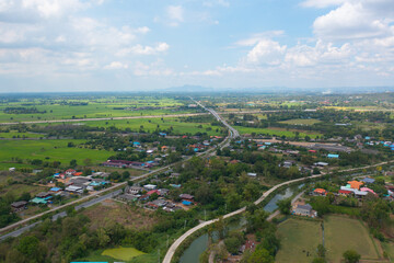 Aerial top view of fresh paddy rice, green agricultural fields in countryside or rural area in Asia, Thailand. Nature landscape