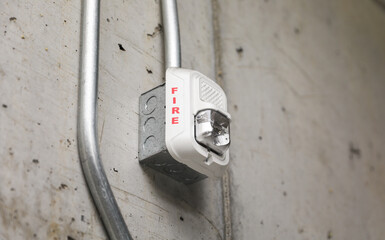 Vivid fire alarm, a symbol of urgency and safety, warns of danger, evoking preparedness and protection in emergencies. Red alert icon