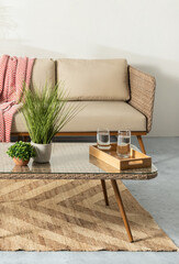 Obraz premium Mid-Century Modern interior living room with tropical style, featuring a rattan wicker lounge chair set and plant decorations. This embodies the concept of a summer living room