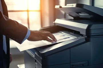 Muurstickers Efficient Office Workflow: Businessman Utilizing Advanced Technology with Multifunction Printer, Scanner, and Copier for Document Processing, Ensuring Productivity and Professionalism in the Workplace © STORYTELLER