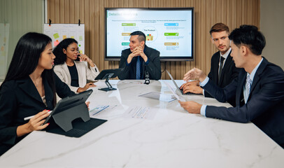 Diverse team innovates for sales KPIs via collaborative brainstorming to develop business models.