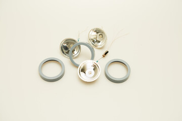 Reflective flashlight components isolated against a white background. 