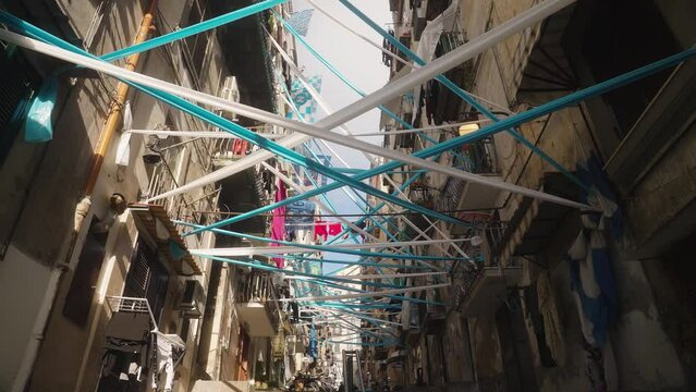 White and blue flag hanging in narrow street of Naples, football attributes