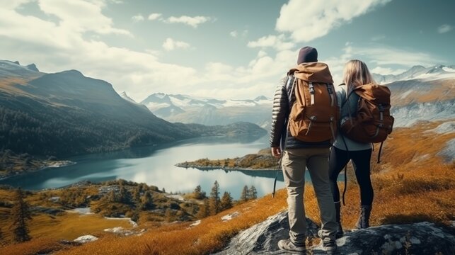back view of a couple taking in the scenery. lake in the mountains. travel with adventure.