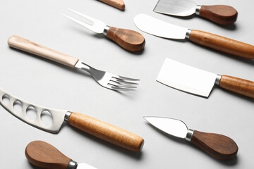 Set of knives and fork on grey background