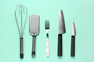Set of kitchen utensils on turquoise background