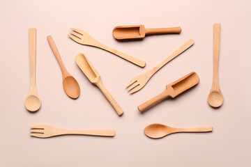 Wooden kitchen utensils on beige background
