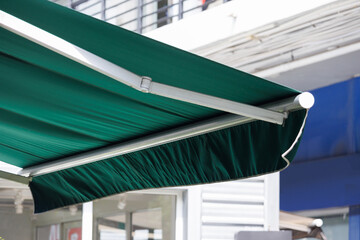 green awning of shop. green canvas roof. - obrazy, fototapety, plakaty