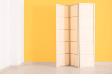 Folding screen near orange wall