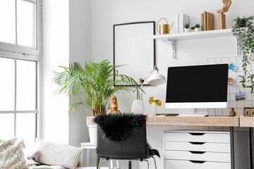 Interior of modern office with workplace and houseplants