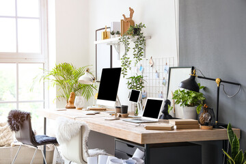Interior of modern office with workplaces and houseplants