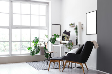 Interior of light office with modern workplace and houseplants