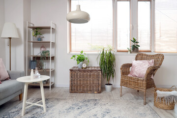 Comfortable armchair, baskets and table in living room