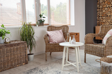 Wicker armchairs, basket and table in living room