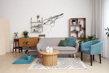 Comfortable armchair, sofa and table in living room