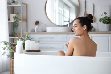 Young woman taking bath at home