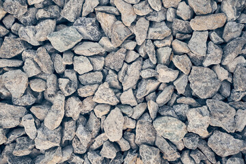 Crushed gray quartz close-up. The industrial fraction is used in the production of building materials, water treatment and agriculture. High quality photo