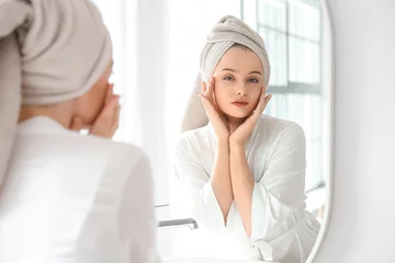 Foto auf Acrylglas Höhenskala Young woman after shower near mirror in bathroom