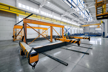 Gantry crane handling accessory to lift metal constructions - obrazy, fototapety, plakaty