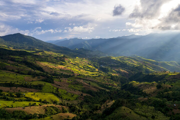 Naklejka premium Top view Landscape of Morning Mist with Mountain Layer at north of Thailand. mountain ridge and clouds in rural jungle bush forest