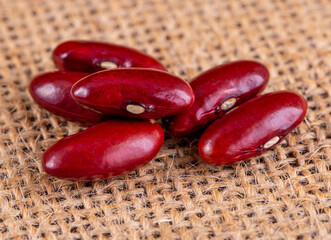 Closeup red beans or kidney bean in wooden bowl isolated on wood table background.