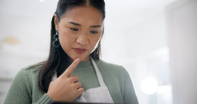 Kitchen, thinking and woman with tablet, doubt or social media with online reading, recipe or ideas. Prepare a meal, confused or Japanese person with technology, home or search internet for food blog