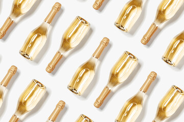 Minimal food pattern with bottles of white sparkling wine, full glass champagne bottles close up,...