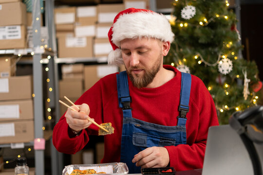 Warehouse Worker Eating Sushi At Workplace Has Lunch Break, Food At Work Concept