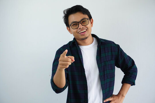 Young Asian Man Showing Excited Expression While Pointing Finger Forward Isolated On White Background