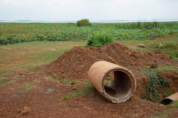 Old broken concrete cement pipe in grass,  Old concrete pipes, Cracked and deteriorated sewer pipes...