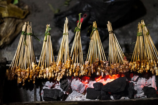 Satay with small cutlets like flies called satay lalat, made from chicken, rabbit or  meat goat satay in grilling place by people with yummy looking. traditional satay from Madura Indonesia