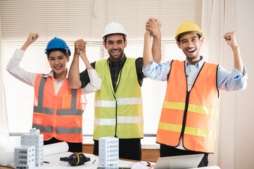 Multi ethnicity group of engineers, architects and construction worker or business people holding colleagues hand showing successful teamwork or unity, Architecture and Engineering business concept.