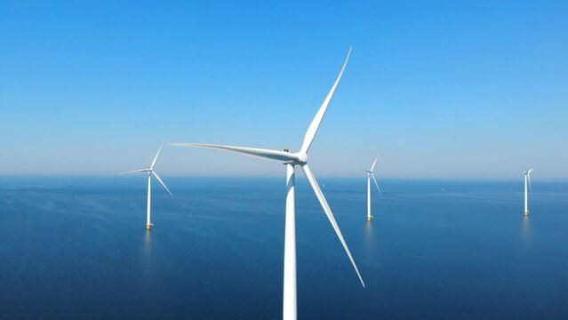 Wind mill turbines park and a blue sky, windmill park in the ocean aerial view with wind turbine Flevoland Netherlands Ijsselmeer. Green Energy production in the Netherlands