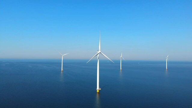 Windmill turbines park with clouds and a blue sky, windmill park in the ocean aerial view with wind turbine Flevoland Netherlands Ijsselmeer. Green Energy production in the Netherlands