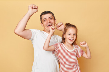 Young parent man have fun with child girl in casual clothes, daddy and daughter dancing on birthday...